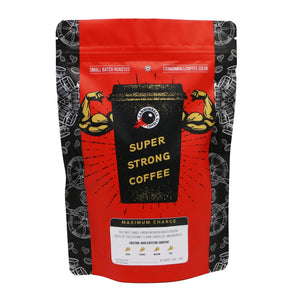 Front of a bag of Cannonball Coffee. The bag has a bright red background. In the centre is a black coffee cup with biceps bursting out of the sides. The cup says ‘Super Strong Coffee’ on it.